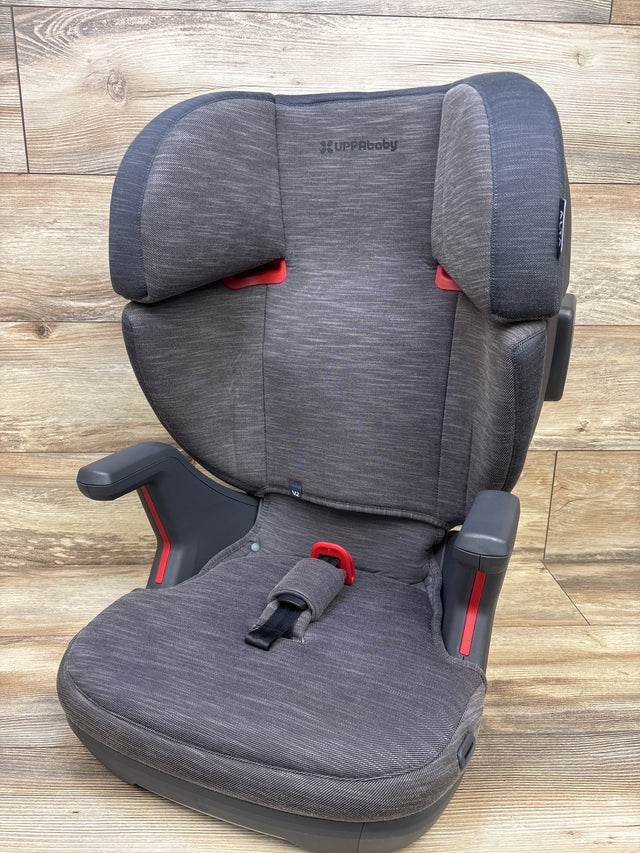 Front view of UPPAbaby Alta V2 High Back Booster Car Seat in Greyson showcasing padded armrests on wood plank background
