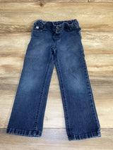Dark wash kids jeans with elastic waistband on wood floor background