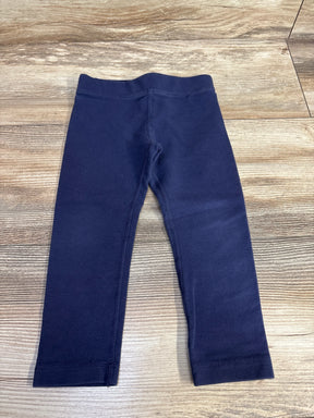 Navy blue toddler leggings on wood floor background