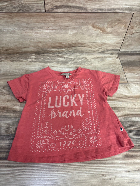 Red Lucky Brand toddler t-shirt with floral and horseshoe design on wood background
