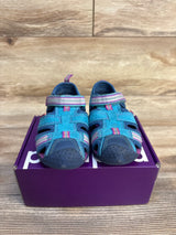 Blue and pink toddler sandals with velcro straps displayed on a purple shoe box