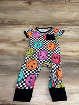 Front view of The Simple Seed bamboo day-to-night romper showcasing colorful smiley faces on a checkerboard print, laid flat on wood