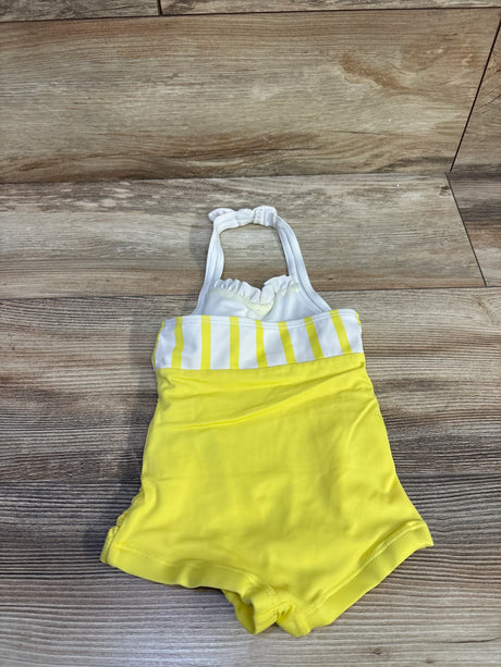 Flat lay of yellow Janie & Jack toddler halter one-piece swimsuit showcasing white striped bust and ruffled halter straps on wood background