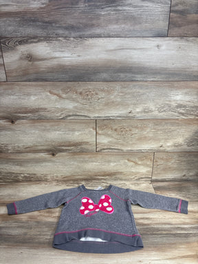 Front view of grey Disney Minnie Mouse toddler sweatshirt (4T) showing pink polka-dot bow applique and pink topstitching on wood floor background