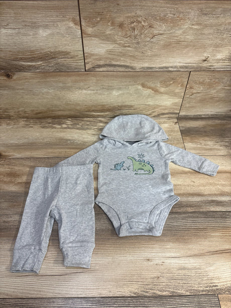 Gray baby outfit set with dinosaur print hooded bodysuit and matching pants on wood background