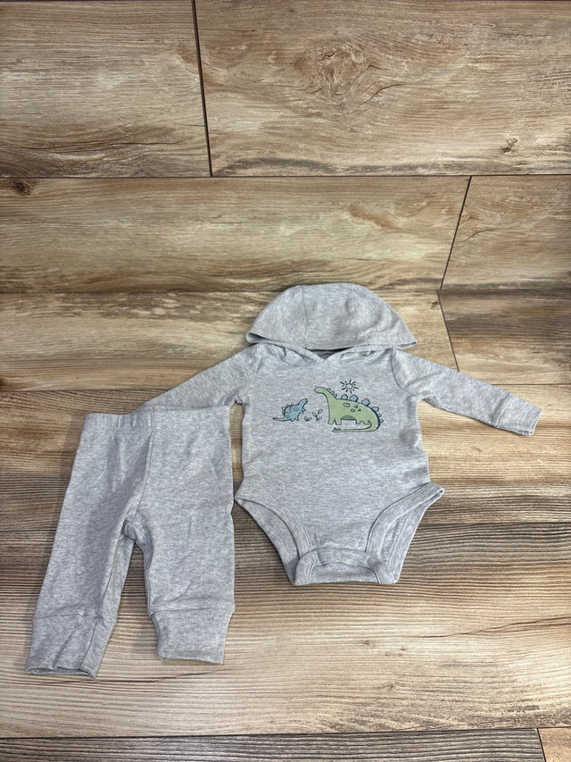 Gray baby outfit set with dinosaur print hooded bodysuit and matching pants on wood background