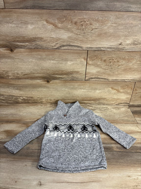 Gray knit toddler sweater with winter-themed black and white patterns on wooden background