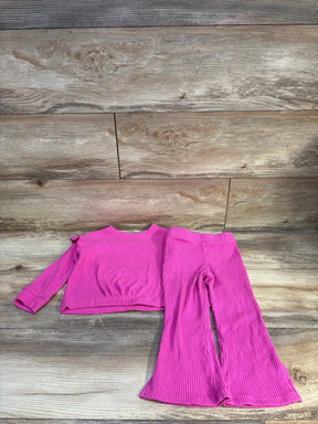 Bright pink ribbed kids outfit with long-sleeve top and flared pants on wood floor