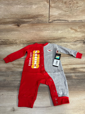 Kansas City Chiefs baby onesie with red and gray split color on wood background