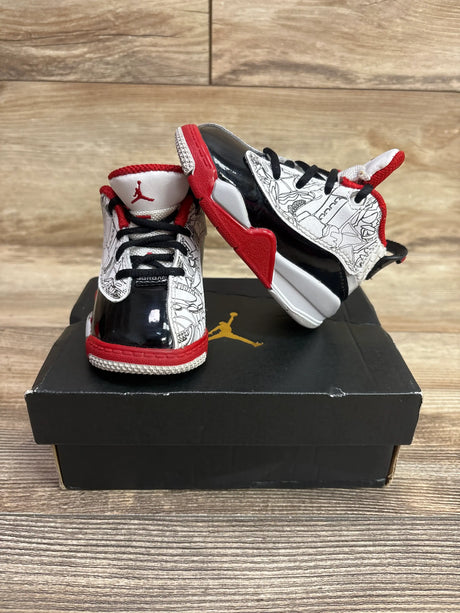 Front and side views of Air Jordan Dub Zero TD Varsity Red sneakers showcasing red, black, and white high tops with a wood floor background