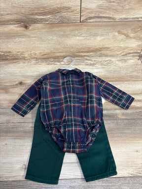 Plaid baby bodysuit with green pants on wood background, baby outfit flat lay