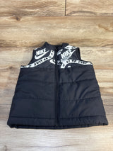 Kids black puffer vest with zipper and white graphic logo print, displayed on wood floor