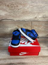 Front three-quarter view of Nike Court Borough Mid 2 toddler sneaker in black and game royal showing Velcro strap on a red Nike box