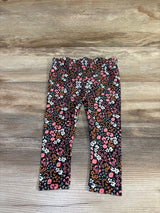 Flat lay Cat & Jack baby leggings, black floral print with pink, white, orange flowers and ruffled waist on wood