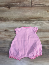 Back view of Simple Joys shortie romper in pink and white stripes showing ruffled cap sleeves and elastic ruffled leg openings on a light wood background