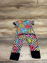 Flat lay of The Simple Seed bamboo day to night romper with colorful smiley faces, checkerboard pattern, and black cuffs