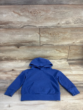 Flat lay of Wonder Nation blue pullover hoodie size 2T showing hood, kangaroo pocket and ribbed cuffs on wood background