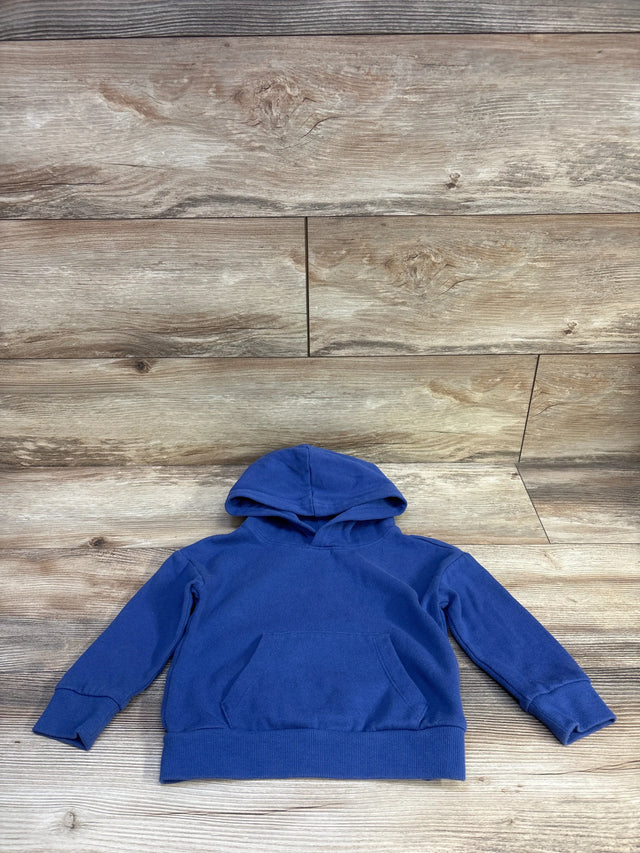 Flat lay of Wonder Nation blue pullover hoodie size 2T showing hood, kangaroo pocket and ribbed cuffs on wood background