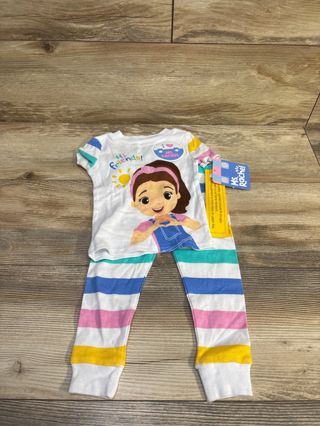 Flat lay of toddler Ms Rachel 2-piece pajamas with white graphic top and multicolor striped leggings on wood floor