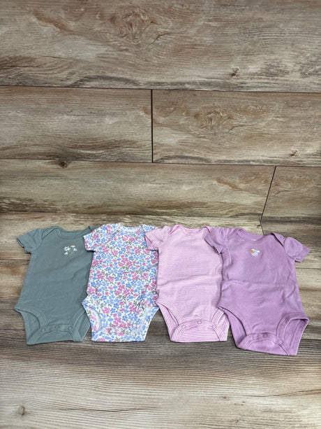 Top view of Carter’s 4pk bodysuit set showcasing gray, floral, pink striped, and purple bodysuits on a wood surface