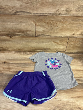 Top-down view of Under Armour 2pc shirt and shorts set showcasing a gray graphic shirt, purple shorts, and blue trim on wood