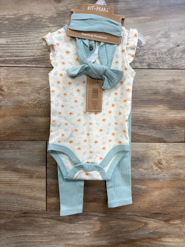 Front flat lay of ivory floral short-sleeve bodysuit with ribbed mint pants and matching mint headband on wood background