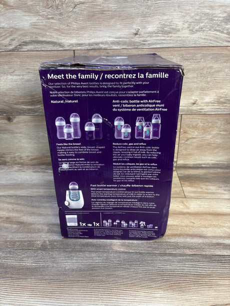 Philips Avent baby bottle and bottle warmer set packaging on wood floor, product details visible.