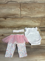 Baby outfit with floral pants, pink tutu, polka dot onesie, and matching headband on wood floor