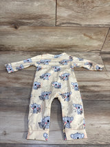 Flat lay of yellow koala coverall showing all-over koala print, long sleeves and fold-over cuffs on wood background