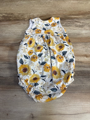 Flat lay of white 4T toddler romper with yellow sunflower print, gathered waist and elastic leg openings on wood background
