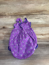 Flat lay of purple Carter's bubble romper showing floral print, ruffled shoulder straps, and elasticized leg openings on wood background