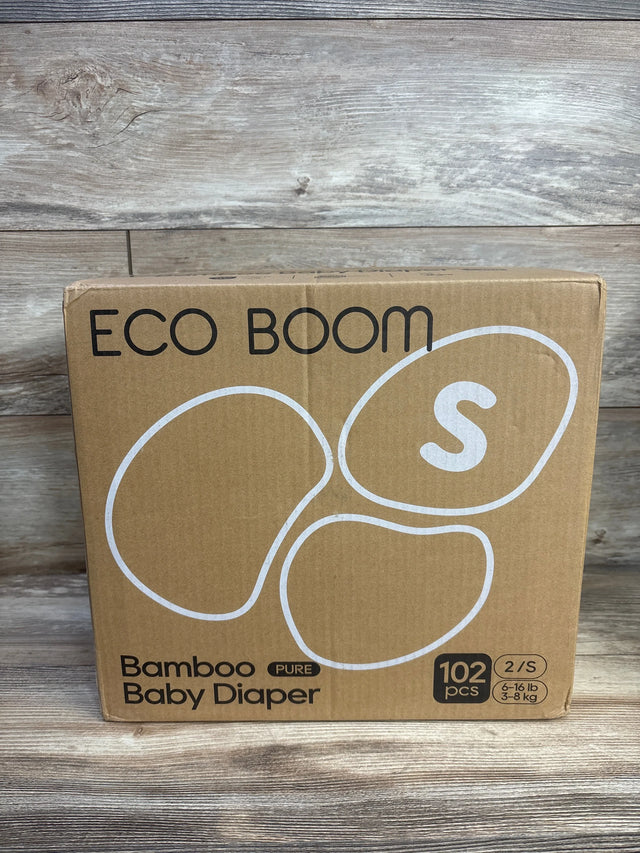 Front view of Eco Boom bamboo baby diaper box showing size S badge, 102-count label and bamboo branding on a wooden surface