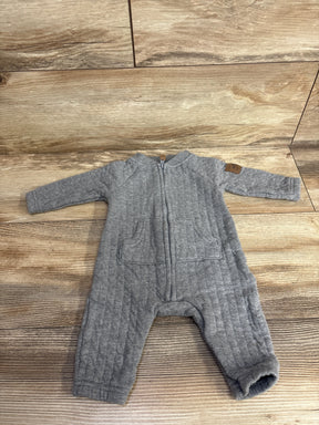 Gray quilted baby romper with zipper and pockets on wood floor, gently used baby clothing