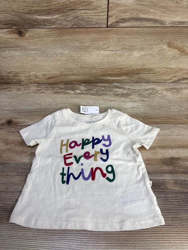 Front view of Baby Gap ivory short-sleeve tee 6-12M showcasing multicolored Happy Everything text on wood background