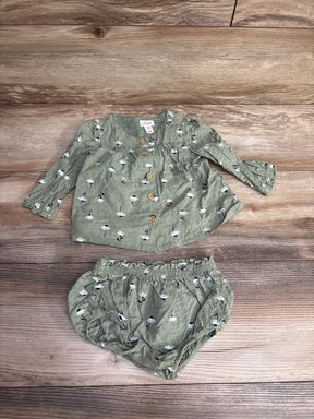 Olive green baby girl two-piece outfit with white daisy print, wooden buttons, long sleeves, and elastic waist bloomers