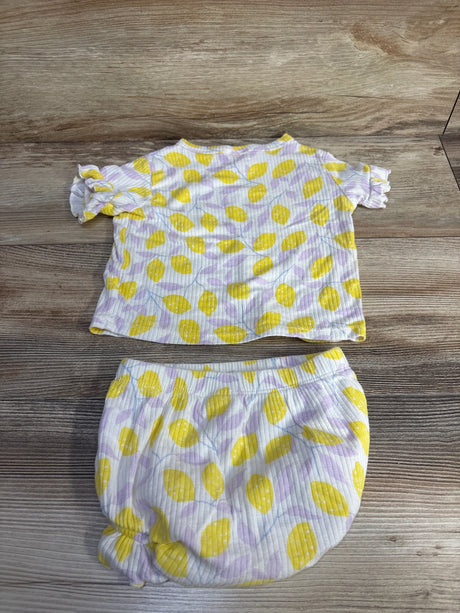 Flat lay of Cat & Jack 2-piece lemon-print ribbed shirt and bloomer set showing ruffle sleeves and elastic waist on wood background