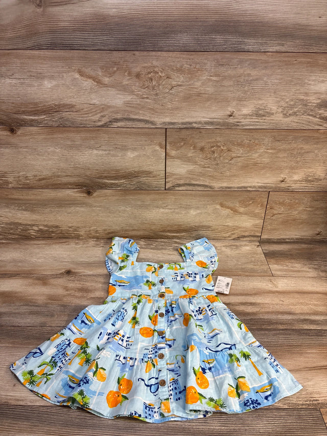Blue baby dress with orange & palm tree print, button front, laid on wood floor