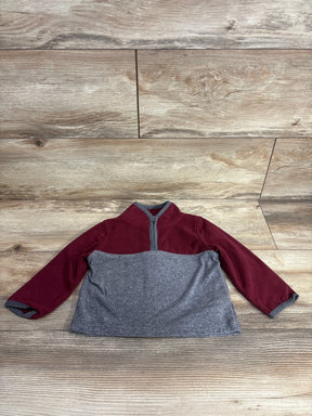 Toddler fleece pullover, maroon and gray, long sleeves, front half-zip, laid flat on wood