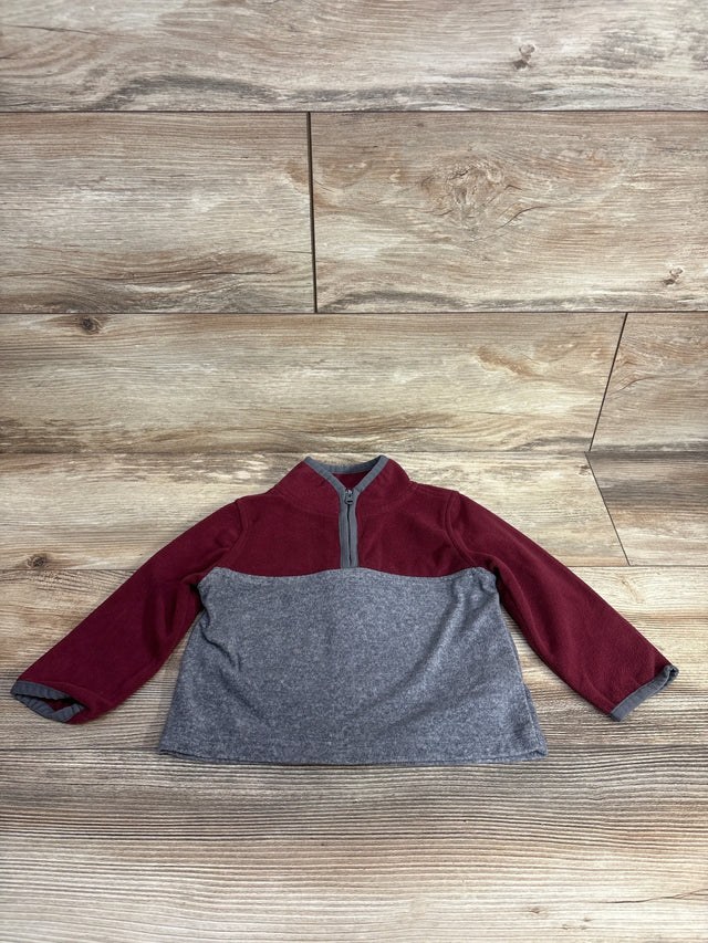 Toddler fleece pullover, maroon and gray, long sleeves, front half-zip, laid flat on wood