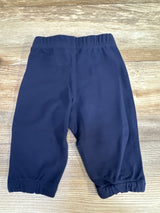 Top down view of navy Ralph Lauren baby sweatpants size 6 months showing elastic waistband and gathered ankle cuffs on light wood background