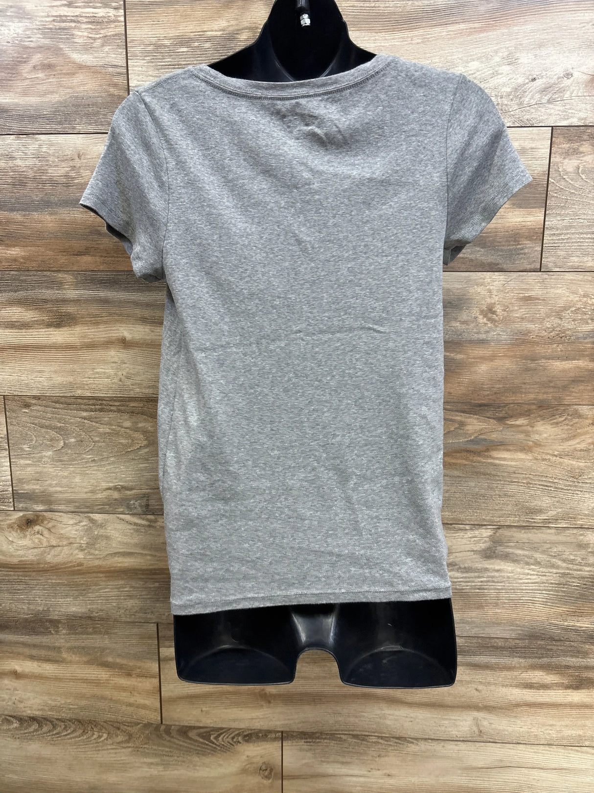Back view of Isabel maternity tee in heather grey showing short sleeves and straight hem on black mannequin with wood plank background