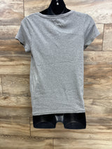 Back view of Isabel maternity tee in heather grey showing short sleeves and straight hem on black mannequin with wood plank background