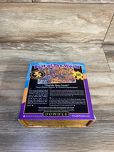 Angled top-down view of Dowdle Best of the World 100-piece jigsaw puzzle box showcasing back artwork and purple border on a wood tabletop