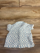 Front view of blue gauze checkered button-up baby shirt showcasing short sleeves and collar on wood background size 6 to 9 months