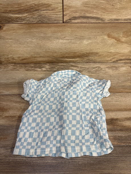 Front view of blue gauze checkered button-up baby shirt showcasing short sleeves and collar on wood background size 6 to 9 months
