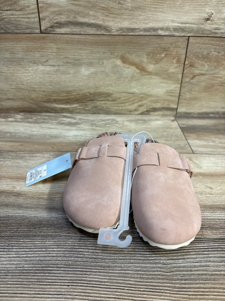 Front view of Cat and Jack toddler clogs in blush with closed-toe suede-look upper, strap and white sole on wood background