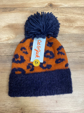 Orange and navy leopard print knit beanie with navy pom pom and Cat & Jack tag on wood surface