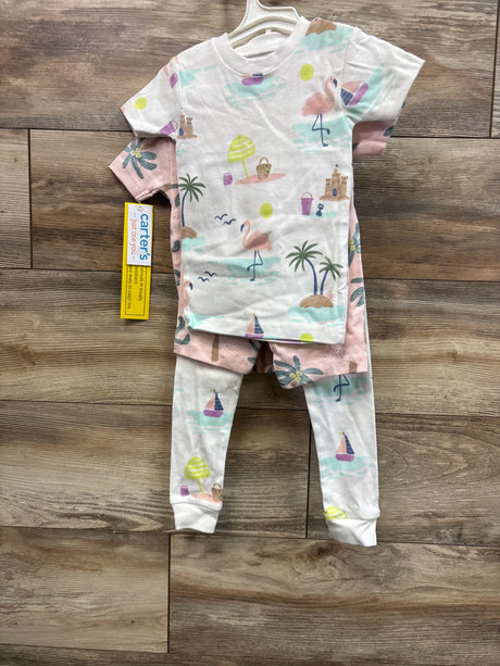 Flat lay of Just One You 4-piece toddler pajama set showcasing palm tree and flamingo beach print on wood floor