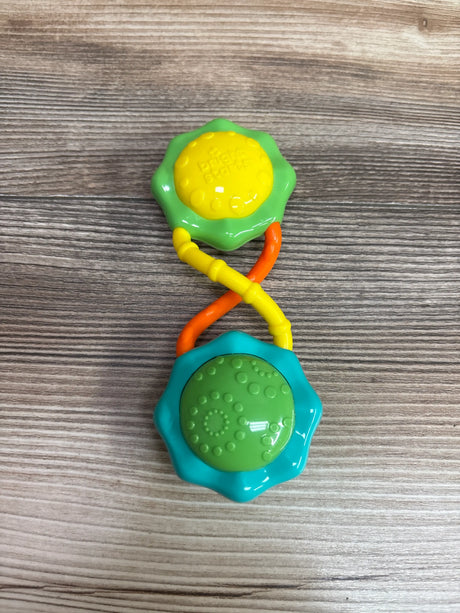 Top view of Bright Starts Rattle and Shake Barbell Toy showing textured ends and colorful handles on wood grain