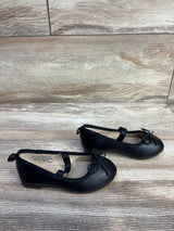Side view of Cat and Jack Nora slip on ballet flats, toddler size 6C, showing elastic strap and bow on light wood background